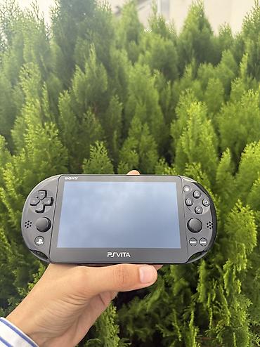 ps disk: Sony PS Vita portativ oyun konsolu. Şəkillərdə qara rəngli cihaz və PS — 1