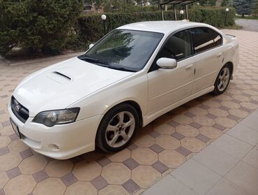 пружины на авто: Белый седан Subaru Legacy с характерным воздухозаборником на капоте
