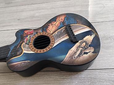 inkişaf etdirici oyuncaqlar: Dekorativ uşaq gitara formasında musiqi aləti. Korpus üzərində — 2