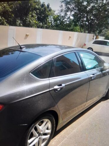 fort focs: Tünd boz rəngdə Ford Fusion sedan avtomobili. Qara rəngli damı və xrom