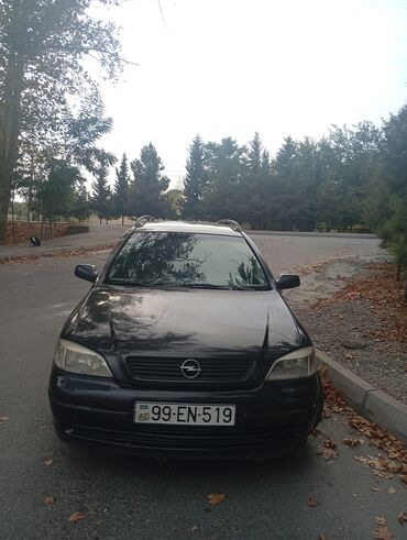 Haima: Opel Astra Caravan (universal) – qara rəngdə, 5 qapılı, AZ nömrə