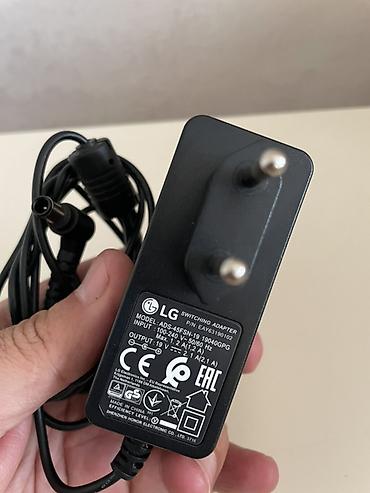 modem adapter: LG orijinal “Switching Adapter” enerji bloku LG televizorunun üstündə — 1
