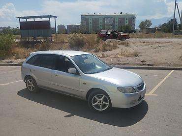 Унаа: Mazda 323: 2003 г., Кол менен иштөөчү, Бензин, Универсал — 2
