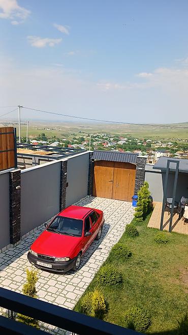 daewoo nexia 2005: Qırmızı rəngli Daewoo Nexia sedan. Avtomobil 4 qapılı kuzova — 2