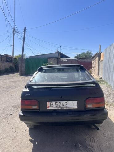 тюнинг мазда 323f слепая: Автомобиль Nissan Sunny, модель B12, представлен в черном цвете. Это