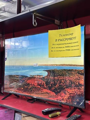 Телевизор с плоским экраном, диагональ ориентировочно 43–50". Тонкие