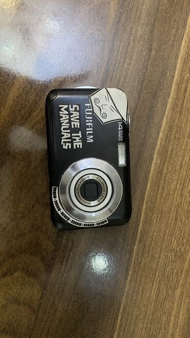 Fujifilm reqemsal/digital kamera. Uzerinde adapter ve yaddas karti