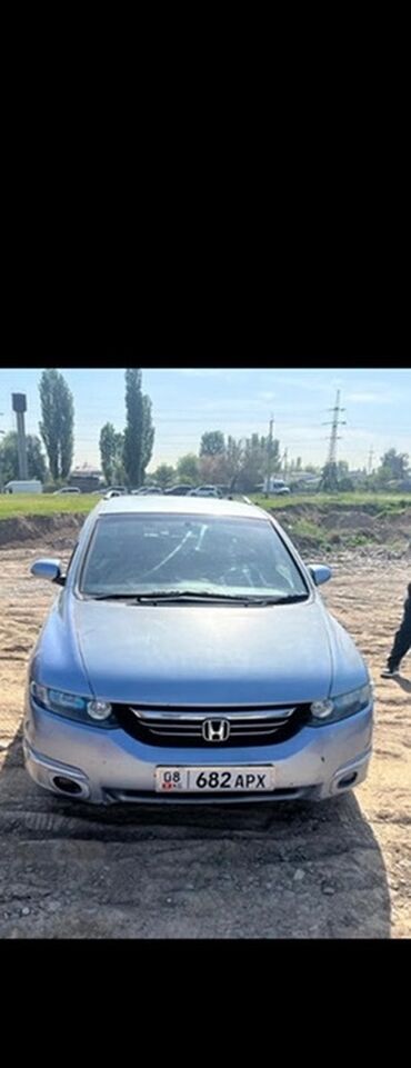 опель внедорожник: Минивэн Honda Odyssey голубого цвета, представленный на снимке