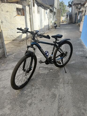 Elektrik velosipedlər: Merach dağ velosipedi, qara rəngdə və mavi detallarla. Velosipedin