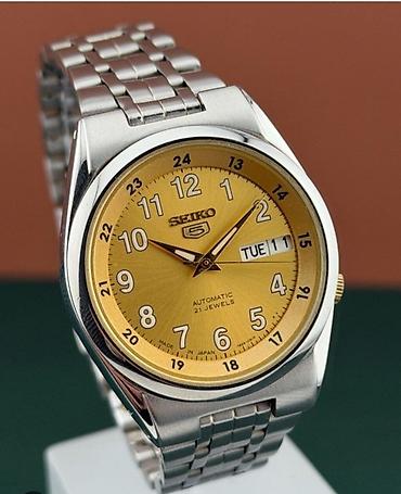 21: Şəkildəki qol saatı, klassik Seiko 5 Automatic 21 Jewels modelidir — 1
