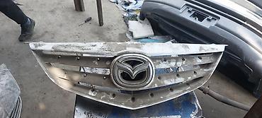 Решетки радиатора: Решетка радиатора Mazda Оригинал — 9