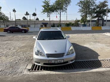 кофр на крышу автомобиля: Серебристый седан Lexus ES 300, оснащенный люком на крыше. Этот