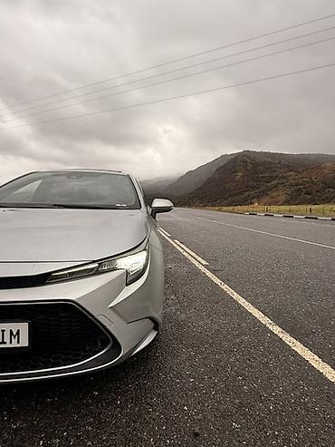 краун 2023: Toyota Corolla: 2021 г., 1.8 л, Вариатор, Гибрид, Седан — 5