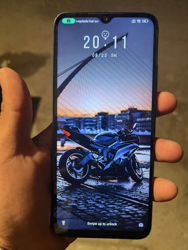 xiaomi mi a3 бу: Göy rəngdə Xiaomi Redmi 10C smartfonu. Cihazın arxa tərəfində "Redmi"