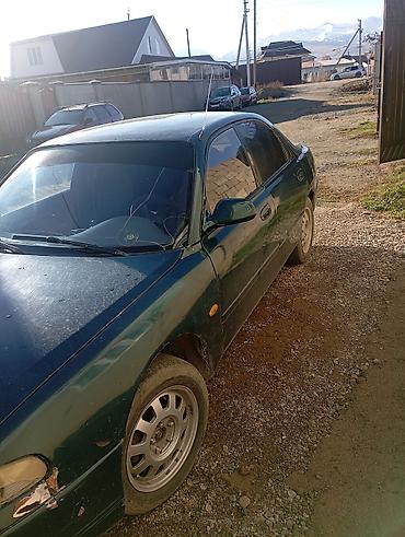 kia spektra: Mazda 323: 1993 г., Седан — 2