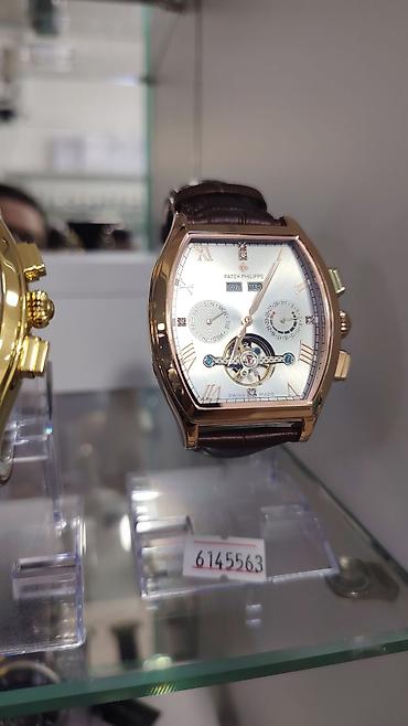 saat omega: Patek Philippe kişi qol saatı – tonneau (yastıqsayağı) korpus dizaynı — 2