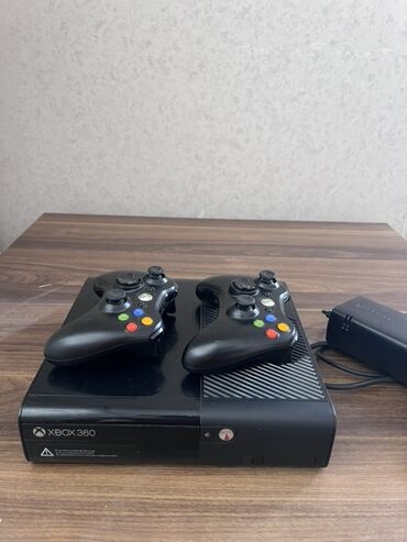 Xbox 360 konsolu iki ədəd uyğun qara rəngli nəzarətçi ilə birlikdə