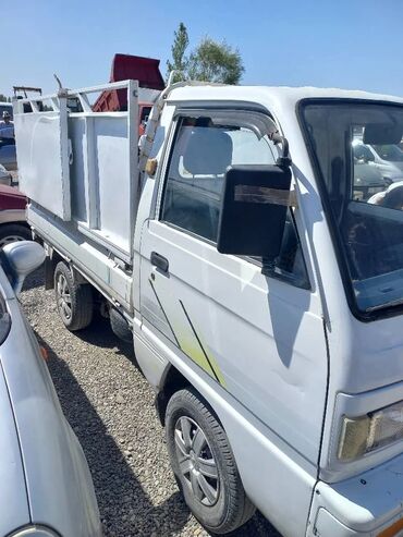 газ оборудование на авто: Грузовой пикап Daewoo Damas белого цвета, оснащенный откидными бортами