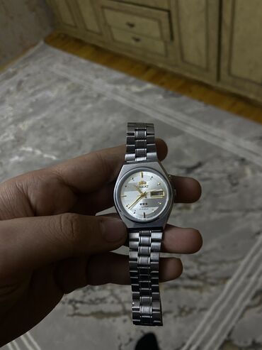 mexaniki saatlar: İşlənmiş, Qol saatı, Orient, rəng - Gümüşü