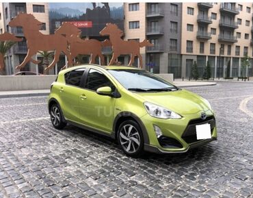 Yaşıl rəngli Toyota Aqua avtomobili, hibrid mühərrikə malikdir