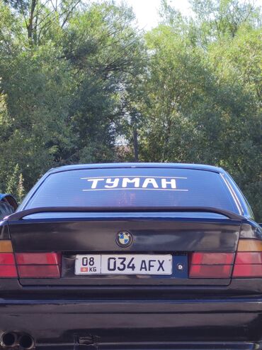 меняю дом на авто: Черный седан BMW E34 с характерным обвесом и задним спойлером. Модель