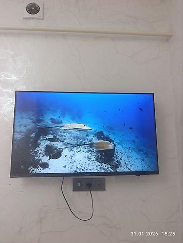 Телевизоры: Телевизор KIVI (надпись на рамке) с тонкими рамками, настенное — 6