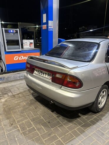 газ оборудование на авто: Mazda Familia седан, серебристый цвет, правый руль. Кузов 4-дверный