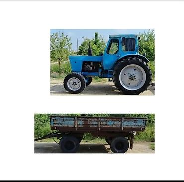 qoşqu yeri: Traktor və qoşqu - Mavi rəngli, kabinəli təkərli traktor. Ön təkərlər — 1
