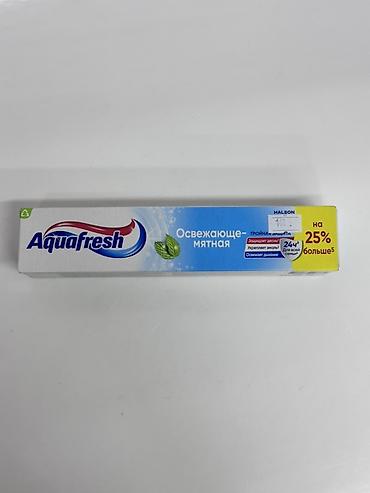 Aquafresh зубная паста «Освежающе-мятная». Особенности: - Тройная