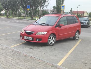 Mazda: Mazda Premacy красного цвета. Этот минивэн с просторным салоном и
