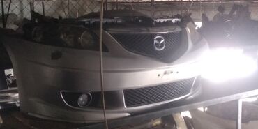 Гидроусилители: Передний Бампер Mazda 2004 г., Б/у, цвет - Белый, Оригинал