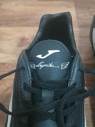Kopačke: Kopačke Joma Aguila – crno‑bele - Model: Joma Aguila (logo i natpis — 12