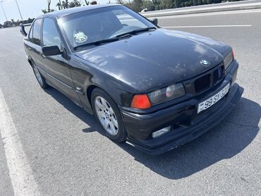 Bu, BMW E36 sedan modelidir. Qara rəngdə olan avtomobil dörd qapıya