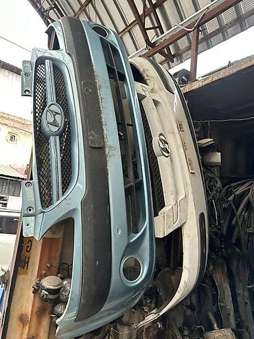 Бампер и комплектующие: Передние кузовные детали для Mazda: - Бамперы передние (с отверстиями — 1