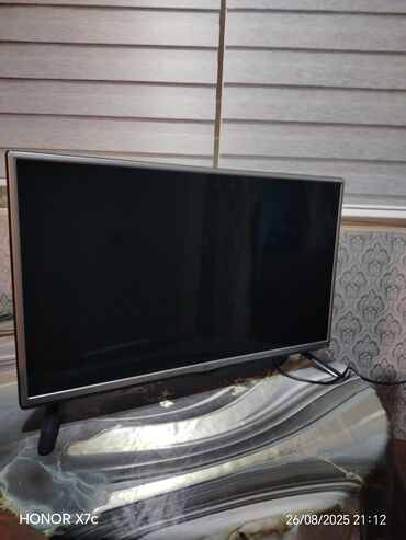 Kasalar: Qara rəngli, nazik çərçivəli LG televizor. Bu model iki dayaq üzərində