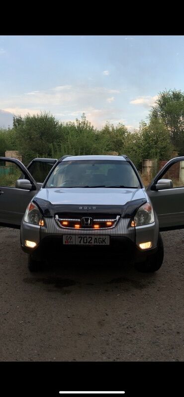прадаю скутер: Серебристый кроссовер Honda CR-V с дополнительными светодиодными