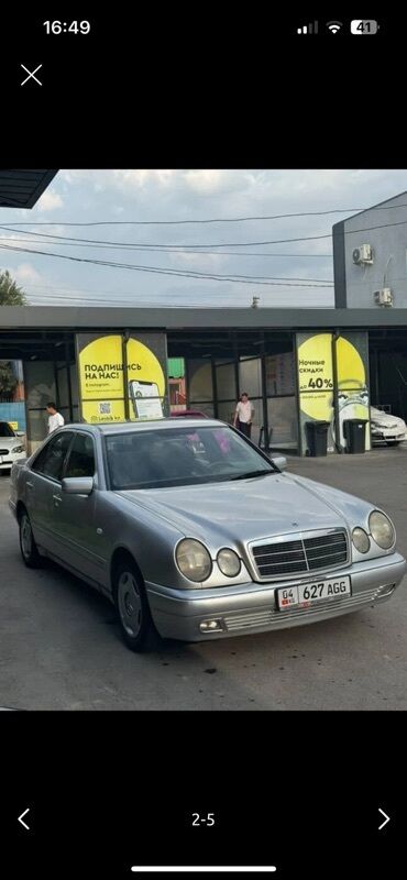 купить передний бампер на мерседес w210 в бишкеке: Серебристый седан Mercedes-Benz E-класса с характерным дизайном фар