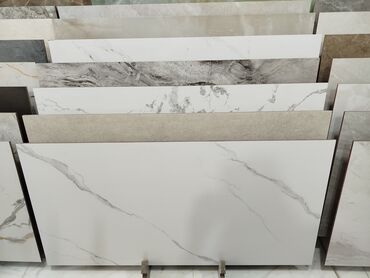 Təmir və tikinti: Ağ rəngdə, mərmər naxışlı keramik plitə. Bu plitə müasir və zərif