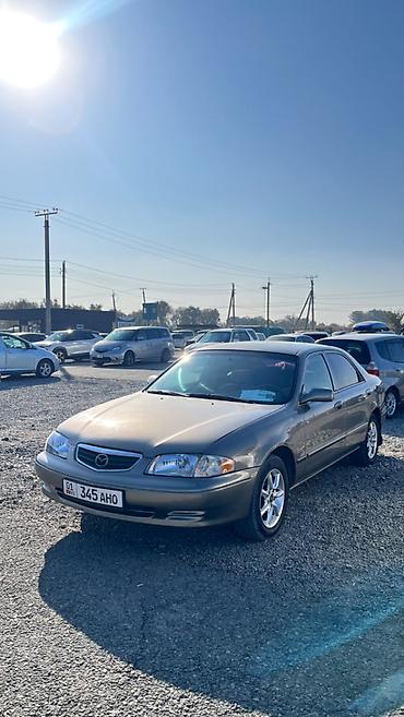 футляр для кия: Mazda Capella: 2001 г., 2 л, Автомат, Бензин, Седан — 1