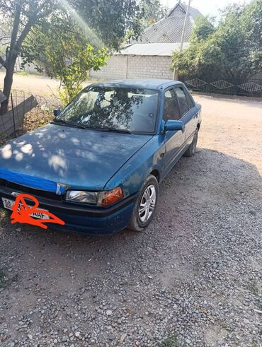 или меняю на дом: Автомобиль Mazda 323 в кузове седан. Окрашен в синий цвет, имеет