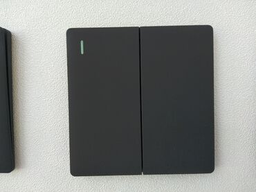 generator mini: Qara rəngdə, divara quraşdırılmış iki açarlı işıqlandırma paneli