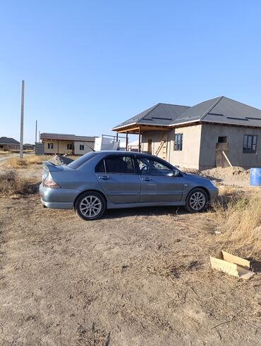машина на обмен с доплатой: Mitsubishi Lancer седан, серый металлик Основные особенности: -