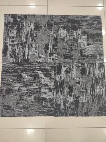 Laminat: A dark gray and light gray carpet tile with an abstract, distressed