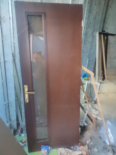 Qoruyucu plyonka və şüşələr: Şəffaf şüşəli, tünd qəhvəyi rəngdə taxta daxili qapı. Bu qapı müasir