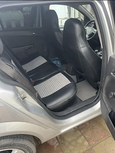 опел: Opel Astra Caravan (universal), gümüşü rəng. Texniki və funksional — 4