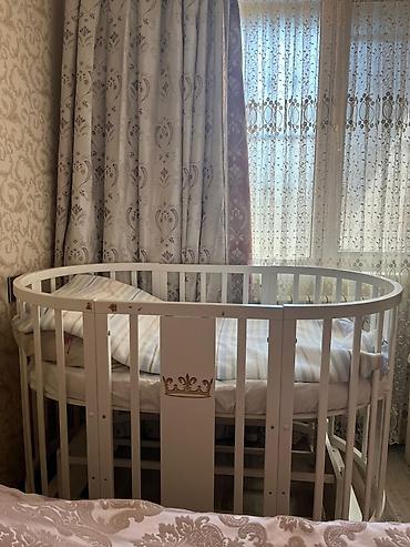 Ev və bağ: Uşaq beşiyi – ağ rəngdə, oval/dairəvi dizayn. Taxta konstruksiya — 1
