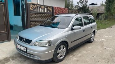 шины на 13 размер: Серебристый универсал Opel Astra, оснащенный багажником на крыше для