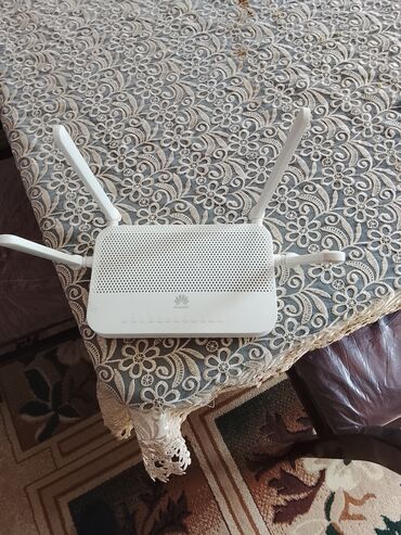 Modemlər və şəbəkə avadanlıqları: Ağ rəngli Huawei Wi-Fi router. Cihazın üst hissəsində havalandırma