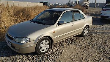 обшивка е34: Mazda 323: 1998 г., 1.5 л, Механика, Бензин, Седан — 1