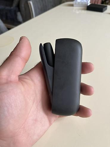 sarlar: IQOS 3 DUO heated tobacco cihazı satılır. Şəkillərdə qara rəngli — 1